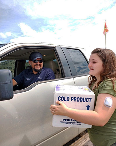 DeVonna Waters took this photo of Ray Gutierrez, Superintendent Maintenance-Shared Services, hand delivering a package of insulin to Dusty Waters after using the access route set up by New Mexico operations during a three-day highway closure.