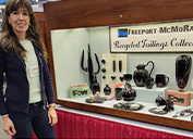 Ormsby shows the products displayed at the show; a decorative pumpkin formed from firepit glass; a cup filled with aggregate made from tailings from the company’s Henderson site in Colorado; and decorative glass tiles featuring the company logo and small round samples showing some of the color options for the formed products.