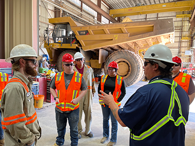 Jayson Janzen (right), Technical Instructor-Thatcher Training Center, leads heavy-equipment maintenance apprentices on a tour of Safford’s truck shop.